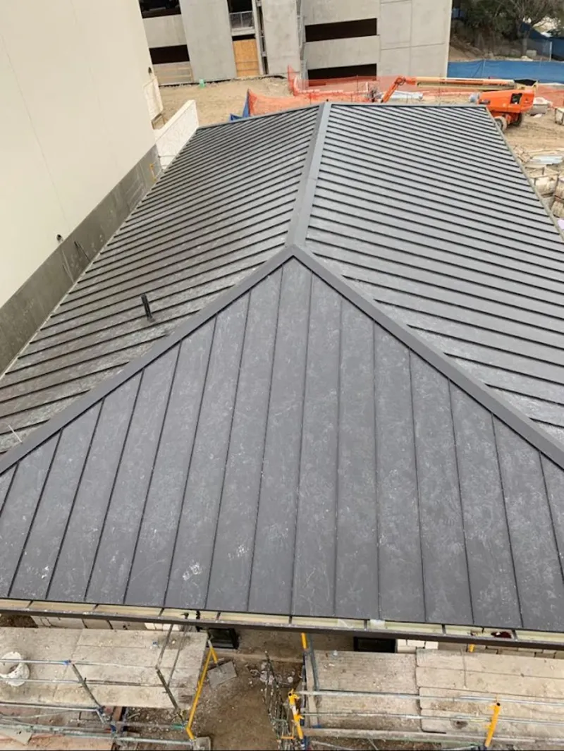 Commercial metal roof construction with crane equipment in Robertsdale