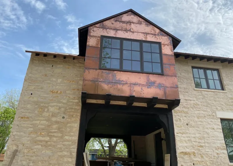 Copper metal panel facade on a stone building for Skylight Installation in Robertsdale