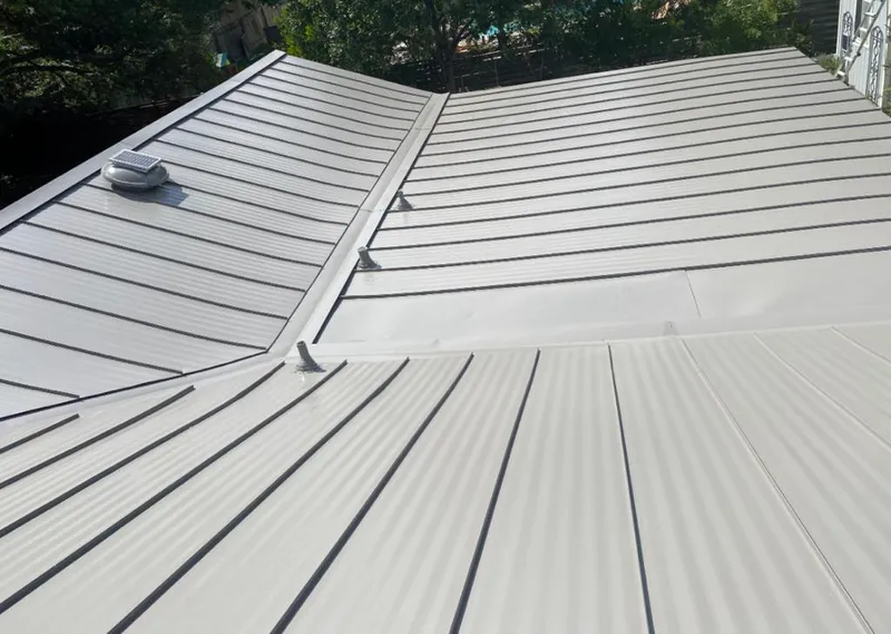 Solar attic fan installed on a metal roof for Roof Ventilation in Robertsdale
